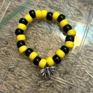 Yellow and black plastic beads with metal bee charm